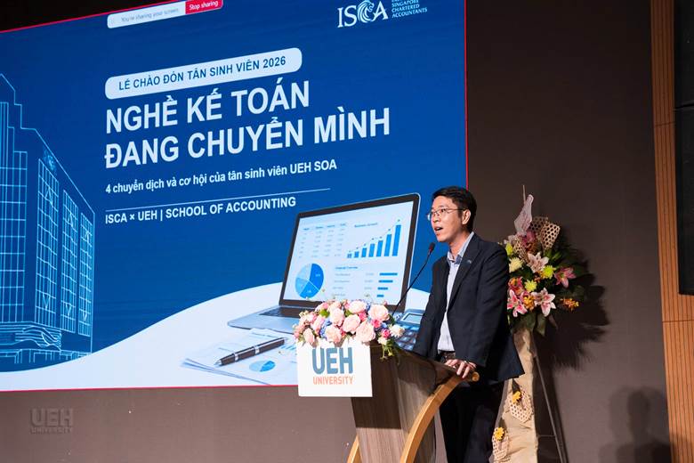 A person standing at a podium with a microphone

AI-generated content may be incorrect.