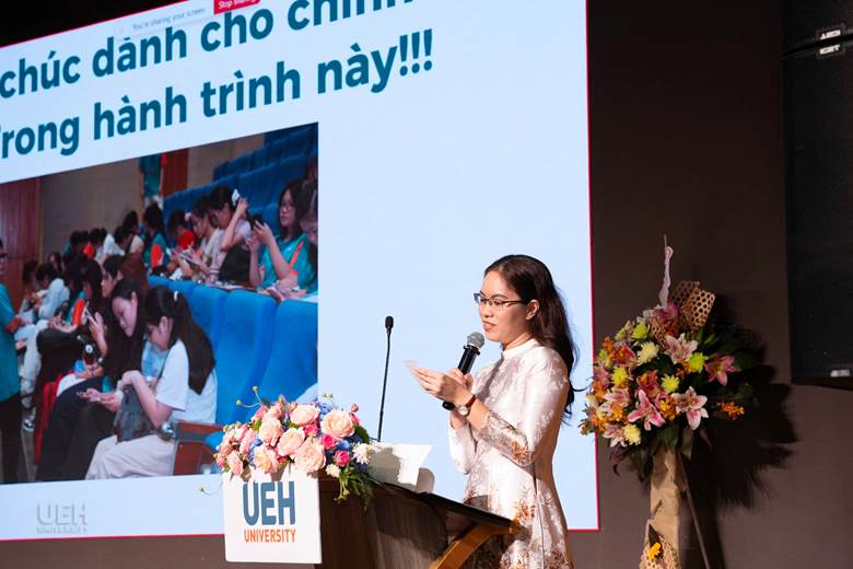 A person standing at a podium with a microphone

AI-generated content may be incorrect.