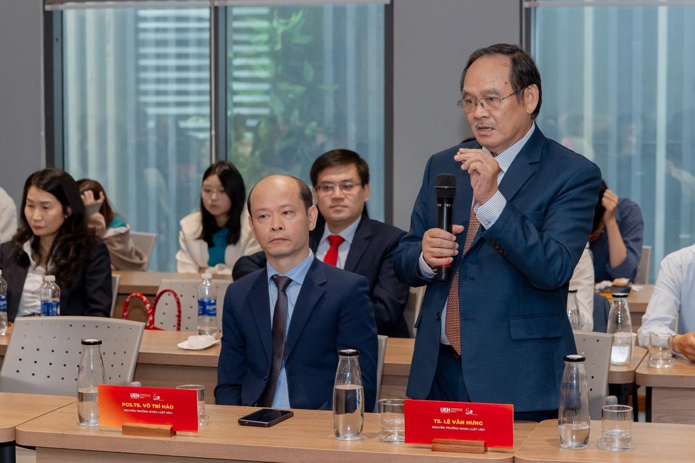 A person in a suit holding a microphone
AI-generated content may be incorrect.